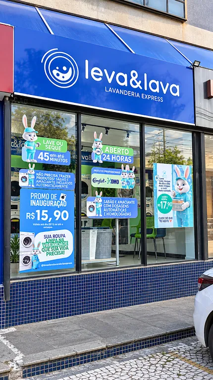 Letreiro Leva & Lava Lavanderia Express e vitrine com avisos de aberto 24 horas e lave ou seque em até 45 minutos